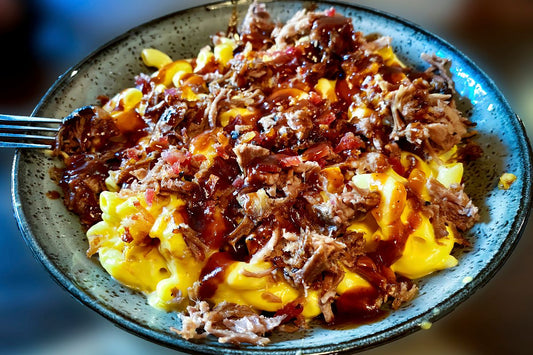 brisket mac and cheese on a blue serving plate